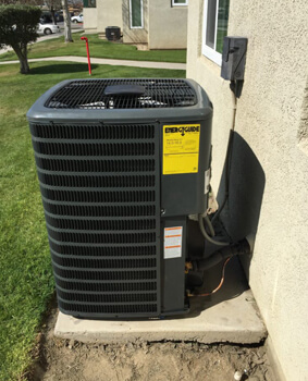 Outdoor air conditioning unit beside a home